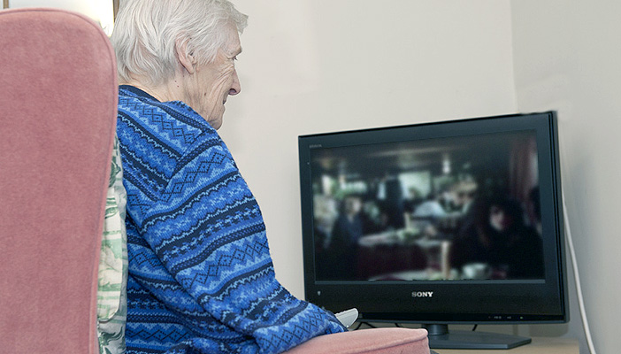 Elderly woman watcing television